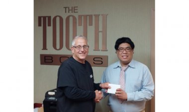 The Toothboss Raises his Cup to Toastmasters Area Director Clive Wan as Its Smiling Neighbor
